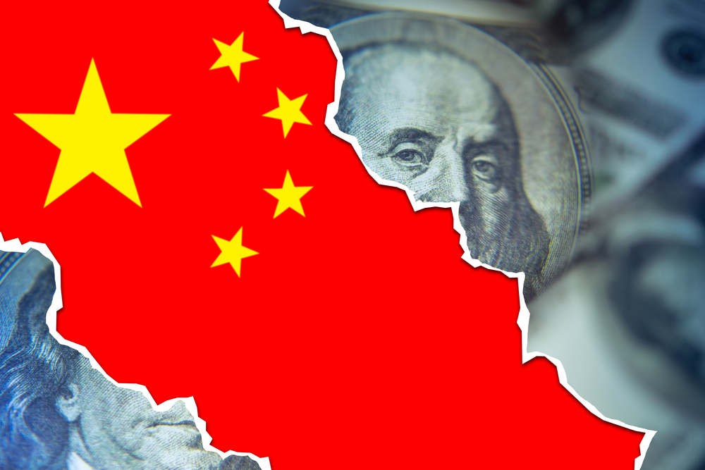 The China Flag Underneath a Torn Dollar Bill