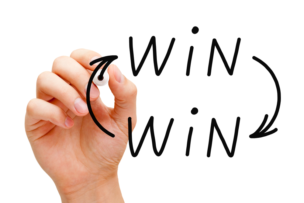 Image of a person drawing an image representing a Win-Win situation